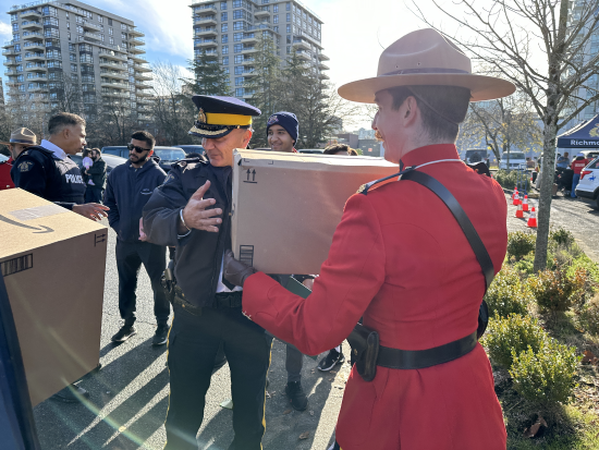 Richmond RCMP officer unloading box from vehicle