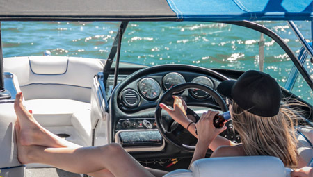 Woman drinking a beer on a boat